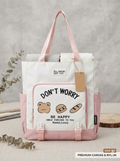 White and pink canvas nylon tote bag with Don't Worry Be Happy graphic print, front zip pocket and side pockets